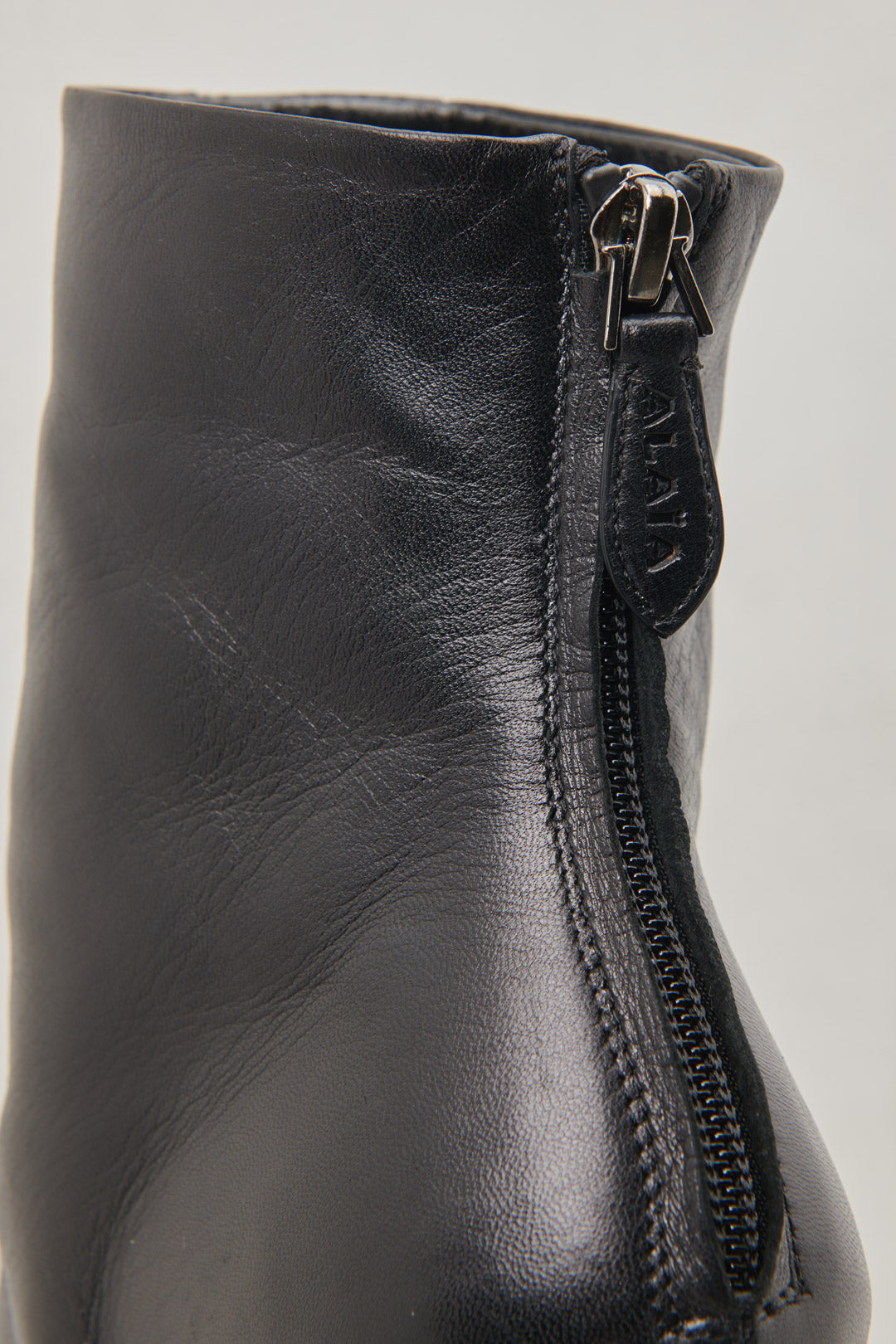 Black ankle boot in nappa calfskin and button decoration