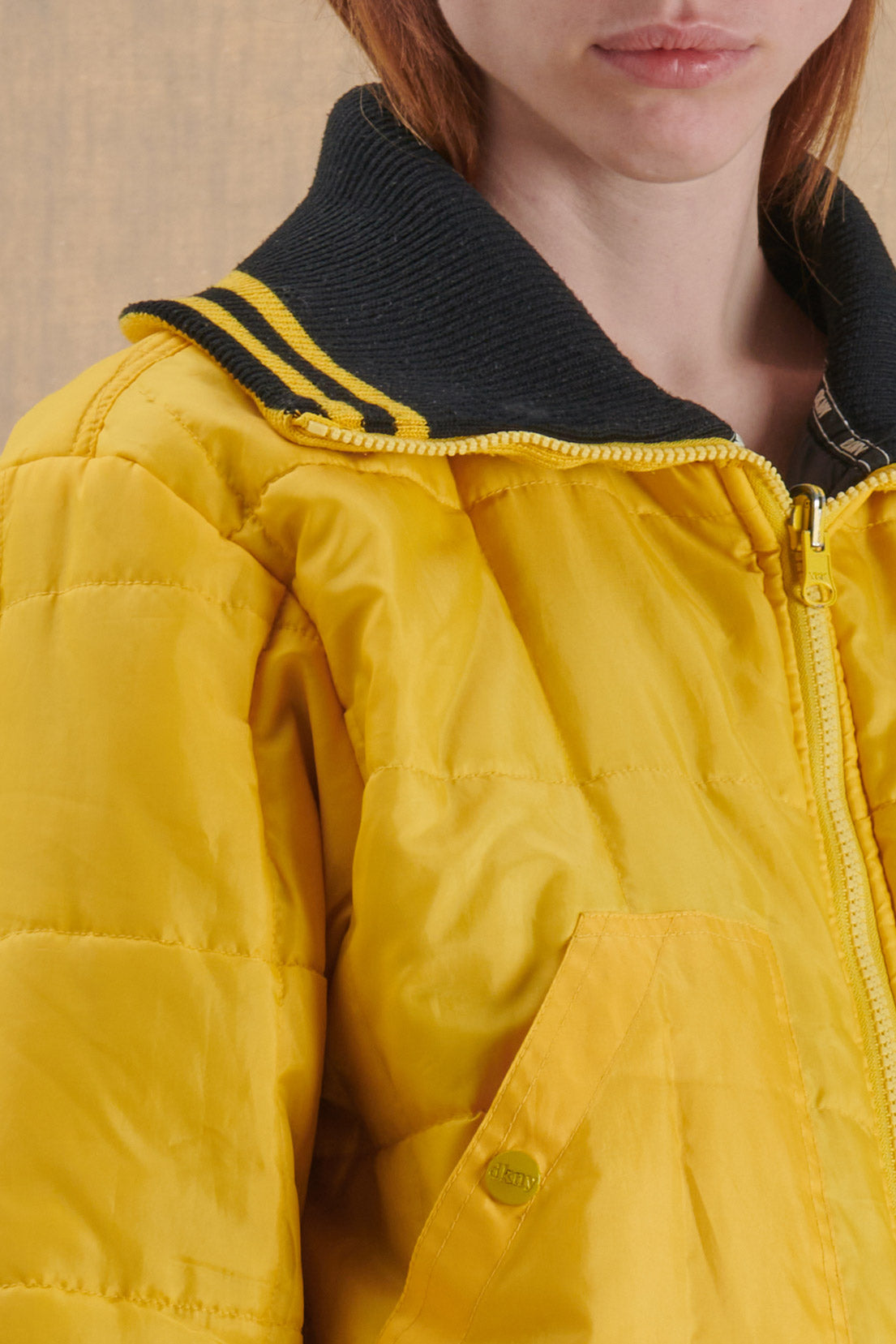 BLACK PUFFER JACKET WITH YELLOW DETAILS